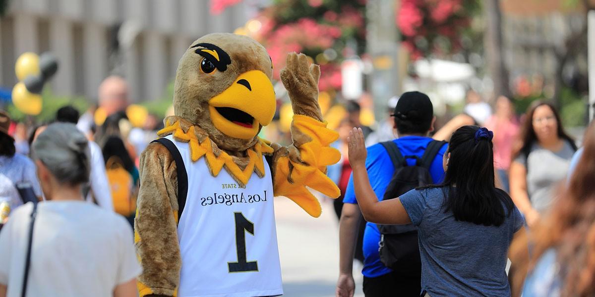 eddie the eagle high 5's student on walkway